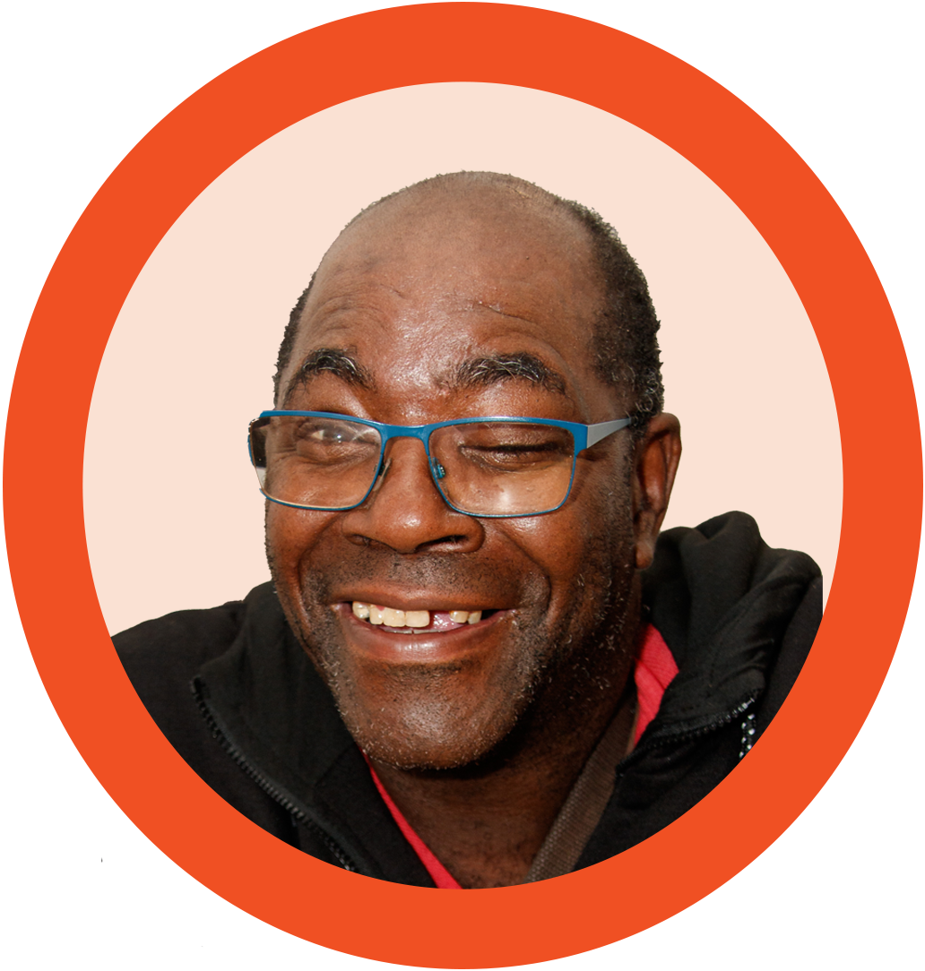 A photo of a man in glasses inside an orange circle