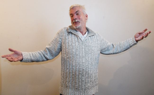 A happy man with his arms spread wide