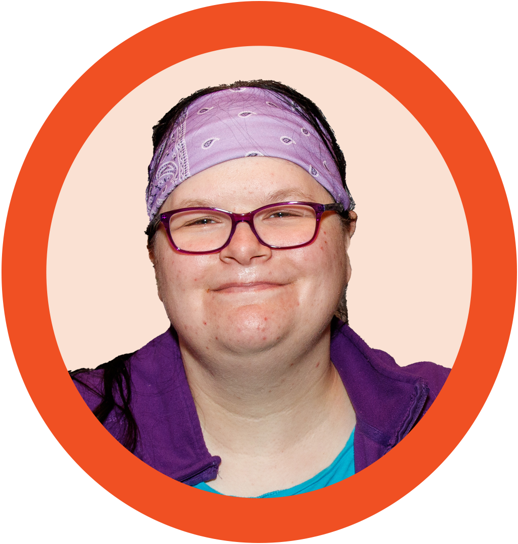 A photo of a woman in glasses and a purple headband