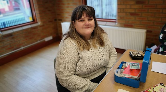 A photo of a woman with a cashbox