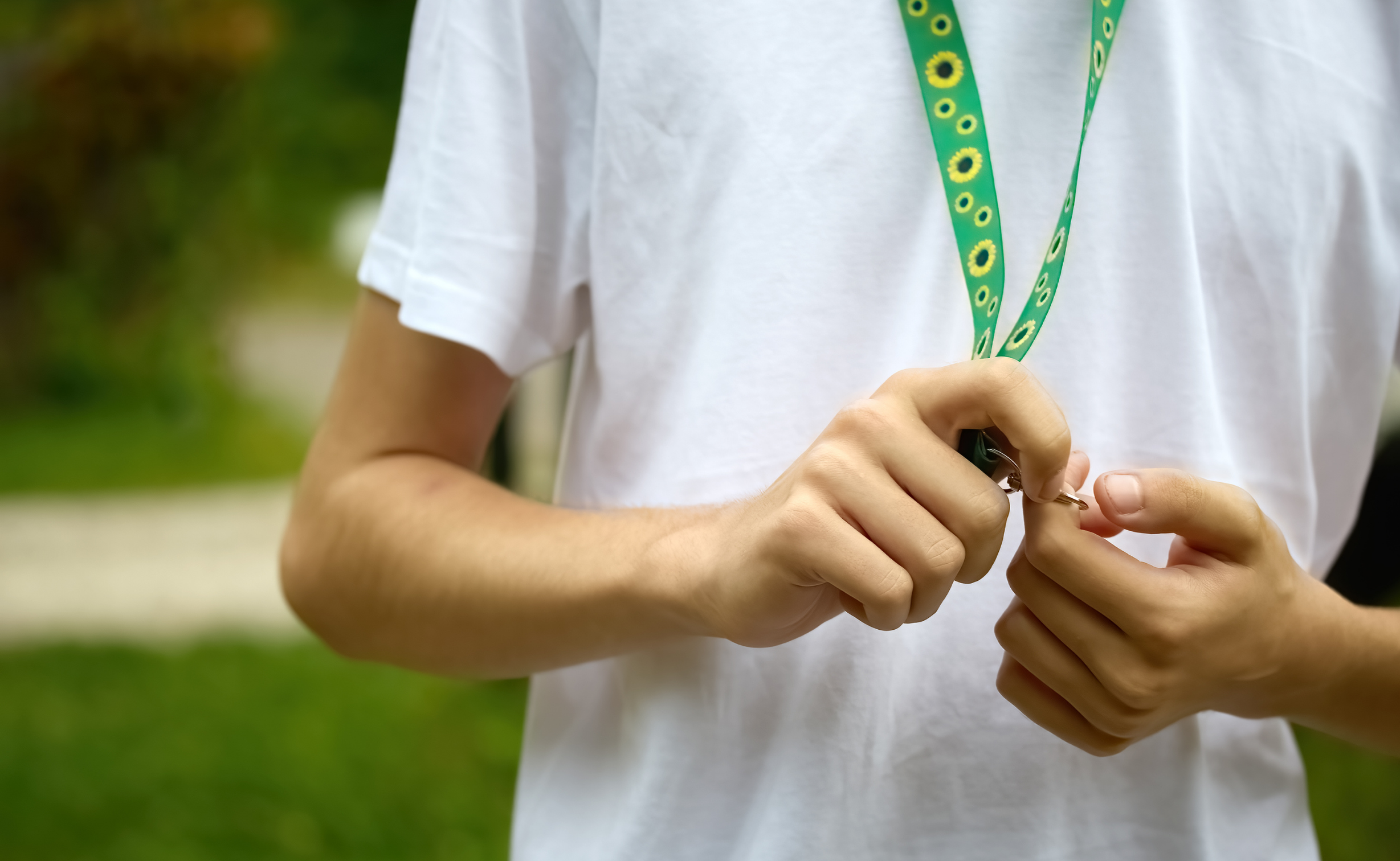 A young person wearing a sunflower lanyard